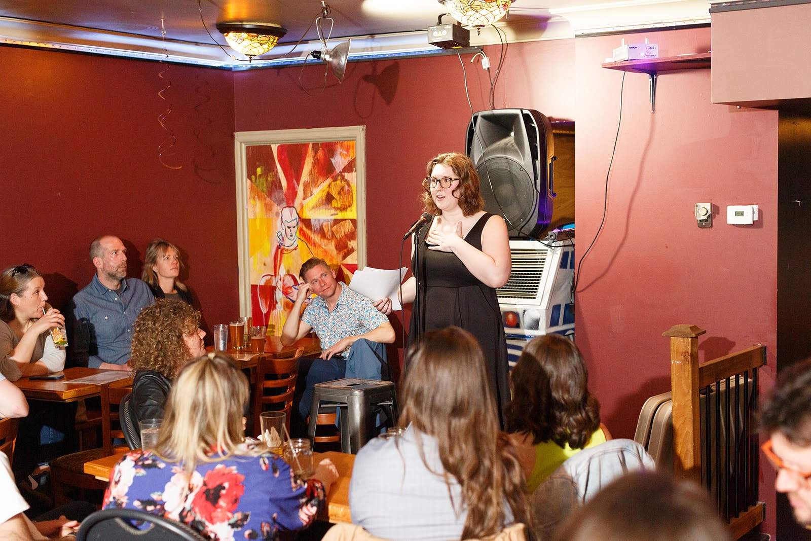 Samantha places her hand on her chest while describing a personal anecdote at the Falling Walls Engage Hub.