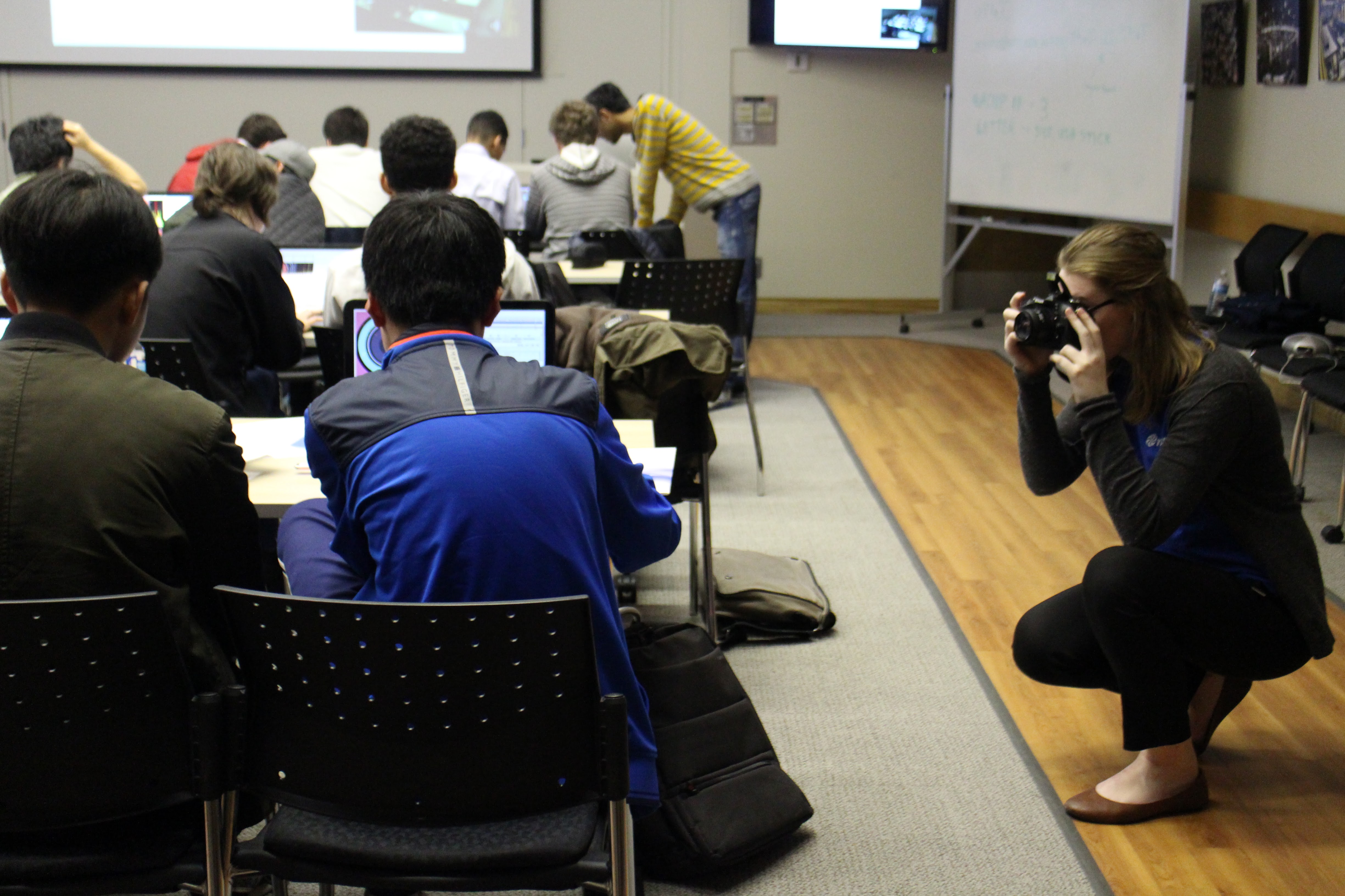 Samantha takes photos of students analyzing CERN ATLAS detector data.